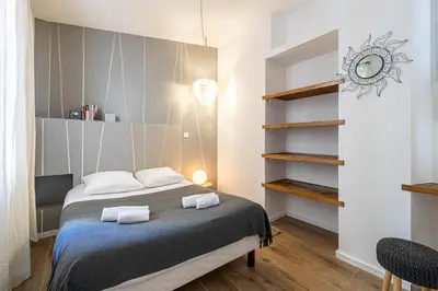 a bedroom with a bed with two towels at Luxurious flat in the heart of Cannes in Cannes