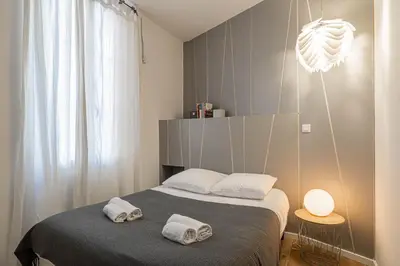 a bedroom with a bed with two towels on it at Luxurious flat in the heart of Cannes in Cannes