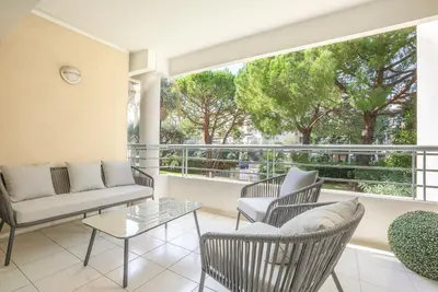 a living room with furniture and a large window at Le Dolce Vita by Winsome Destination in Cannes
