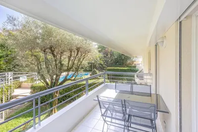 a balcony with two chairs and a table at Le Dolce Vita by Winsome Destination in Cannes