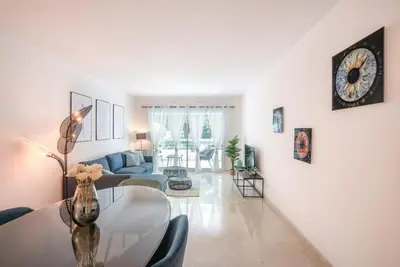 a living room with a table and a couch at Le Dolce Vita by Winsome Destination in Cannes
