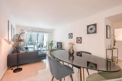 a living room with a table and a couch at Le Dolce Vita by Winsome Destination in Cannes