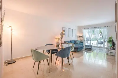 a living room with a dining room table and chairs at Le Dolce Vita by Winsome Destination in Cannes