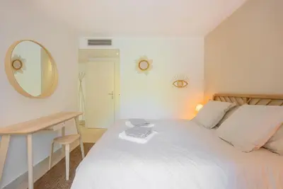 a bedroom with a bed with a mirror and a desk at Le Dolce Vita by Winsome Destination in Cannes