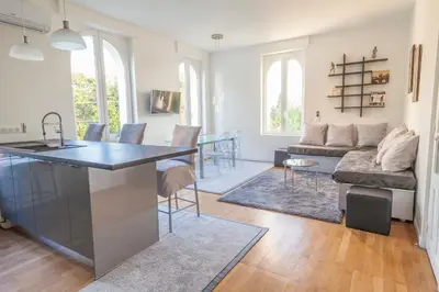 a kitchen and living room with a couch and a table at CLOSE CROISETTE-MODERN-A/C-CONGRESS-BEACHES in Cannes