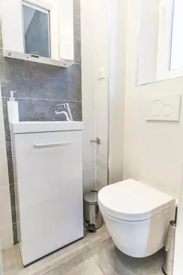 a white bathroom with a toilet and a sink at CLOSE CROISETTE-MODERN-A/C-CONGRESS-BEACHES in Cannes