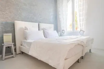 a white bedroom with a large bed with white sheets at CLOSE CROISETTE-MODERN-A/C-CONGRESS-BEACHES in Cannes