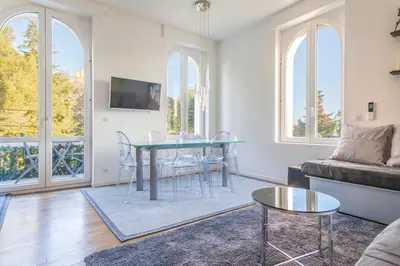 a living room with a table and a couch at CLOSE CROISETTE-MODERN-A/C-CONGRESS-BEACHES in Cannes