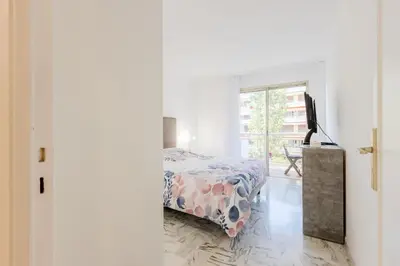 a bedroom with a bed and a window at Renovated 3-Room Apartment in a Leafy Park in Cannes