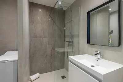 a bathroom with a sink and a shower with a mirror at Agence des Résidences - Appartements privés du 45 CROISETTE - Superieur in Cannes