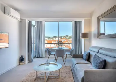 a living room with a couch and a table at Agence des Résidences - Appartements privés du 45 CROISETTE - Superieur in Cannes