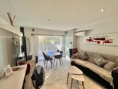 a living room with a couch and a table at Jolies Lavandes, by Welcome to Cannes in Cannes