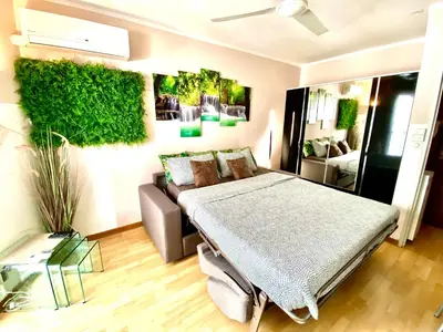 a bedroom with a bed and a couch at Le Nouveau Port By SCLS Locations in Cannes