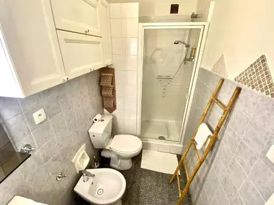 a small bathroom with a toilet and a shower at Le Nouveau Port By SCLS Locations in Cannes