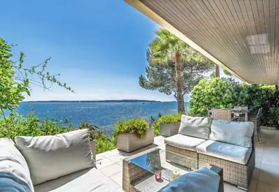 a patio with couches and a view of the water at ADRIANA by Terry's Homes WATERFRONT SEAVIEW BEACH in Cannes