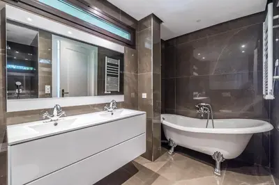 a bathroom with a tub and a sink and mirror at ADRIANA by Terry's Homes WATERFRONT SEAVIEW BEACH in Cannes