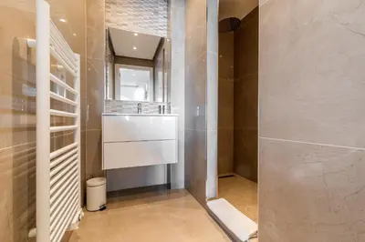 a bathroom with a sink and a mirror at ADRIANA by Terry's Homes WATERFRONT SEAVIEW BEACH in Cannes