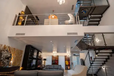 a living room with a spiral staircase in a house at Venue C - Luxurious & Spacious - Mansion - Elevator - Patio in Cannes