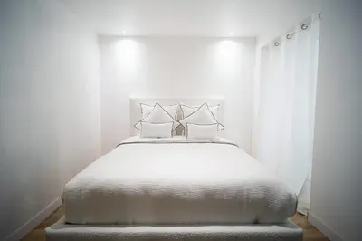 a white bedroom with a white bed with white curtains at Venue C - Luxurious & Spacious - Mansion - Elevator - Patio in Cannes