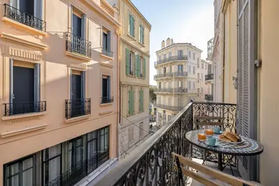 a balcony with a table with food on it at Appartement 2P centre de Cannes avec balcon in Cannes