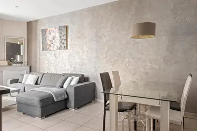 a living room with a couch and a table at Appartement 2P centre de Cannes avec balcon in Cannes