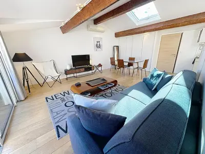 a living room with a blue couch and a table at Rooftop terrasse 1 bedroom in rue d'Antibes, 5 min from the Croisette 214 in Cannes
