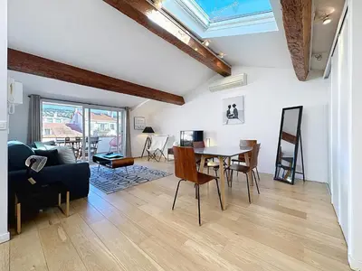a living room with a table and chairs at Rooftop terrasse 1 bedroom in rue d'Antibes, 5 min from the Croisette 214 in Cannes