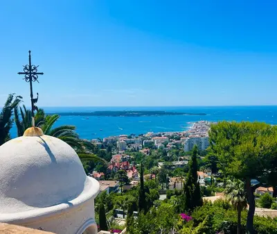 a view of a city with a cross on top of a building at Somptuous exotic villa in Cannes in Cannes
