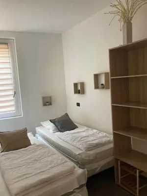 a bedroom with two beds and a book shelf at Beau meublé 3 pièces 60 m² Cannes Le Suquet in Cannes