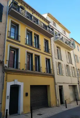 a yellow building with a garage at Beau meublé 3 pièces 60 m² Cannes Le Suquet in Cannes
