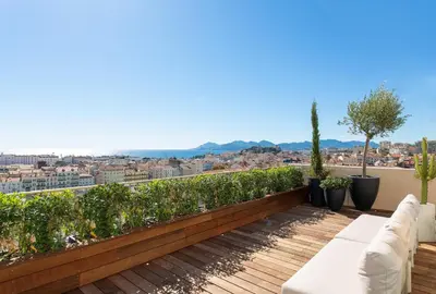 a balcony with white furniture and a view of the city at Rooftop View - 2 BdR 2 BthR 1 toil - Clim Terrace Elevator small Parking in Cannes