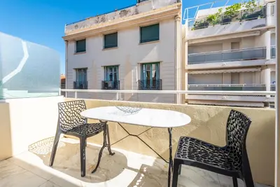 a table and two chairs on a balcony with a table and chairs at Large studio - 50m Cannes beach - terrace sea view in Cannes