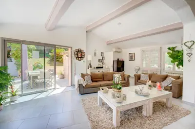 a living room with a couch and a table at MAGNIFIQUE VILLA 8 PERSONNES in Vallauris