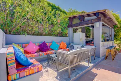 a patio with a couch and a table and chairs at MAGNIFIQUE VILLA 8 PERSONNES in Vallauris