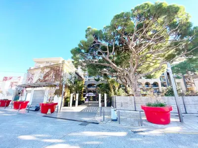a swimming pool in front of a apartment building at à 10 min de la Croisette - pieds dans la mer in Cannes