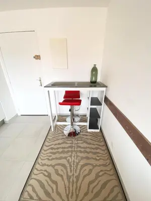 a red chair sitting at a desk in a room at à 10 min de la Croisette - pieds dans la mer in Cannes