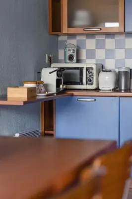 a microwave sitting on a counter in a kitchen at la petit maisonette de manu in Cannes