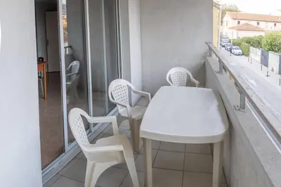 a white table and chairs on a balcony at la petit maisonette de manu in Cannes