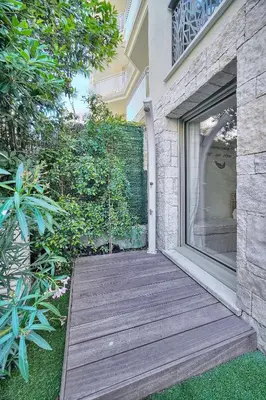 a wooden walkway leading to the door of a house at IMMOGROOM - Garden - Bikes - BBQ - Parking - AC in Cannes