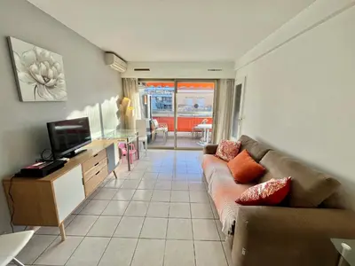 a living room with a couch and a tv at Kent studio by Welcome to Cannes in Cannes