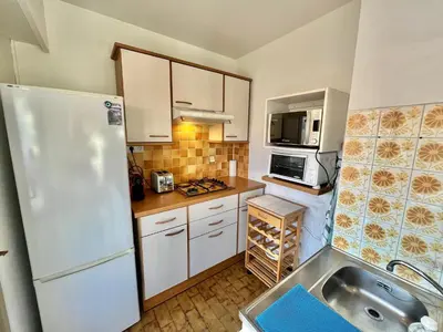 a kitchen with a white refrigerator and a sink at Kent studio by Welcome to Cannes in Cannes