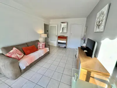 a living room with a couch and a television at Kent studio by Welcome to Cannes in Cannes