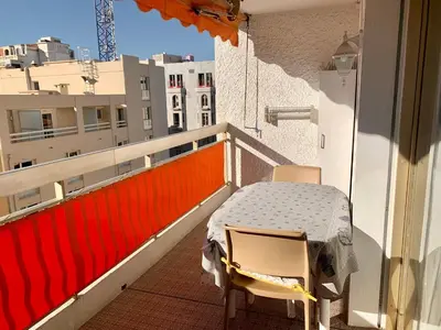 a balcony with a table and two chairs on a building at Kent studio by Welcome to Cannes in Cannes