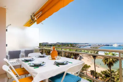 a table and chairs on a balcony with a view of the beach at On la Croisette XXL 1 bedroom with amazing sea view in Cannes