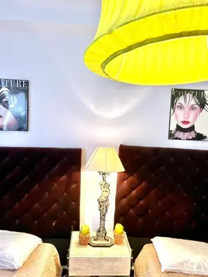 a bedroom with a bed and a lamp on a night stand at LUXURY APARTMENT between ANTIBS and CROISETTE in Cannes