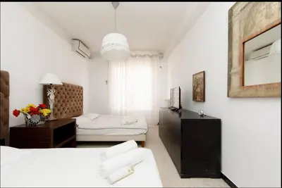 a white room with two beds and a mirror at LUXURY APARTMENT between ANTIBS and CROISETTE in Cannes