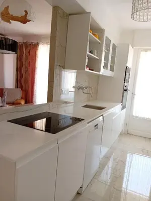 a white kitchen with white cabinets and a sink at LUXURY APARTMENT between ANTIBS and CROISETTE in Cannes