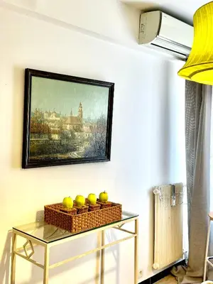 a table with fruit on it with a painting on the wall at LUXURY APARTMENT between ANTIBS and CROISETTE in Cannes