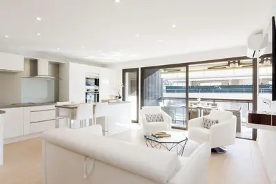 a white living room with a white couch and chairs at Carlton area XXL luxe 1 bed with large terrace in Cannes