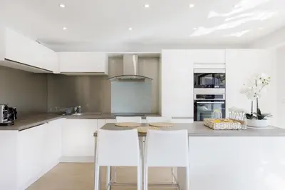 a woman standing on top of a balcony at Carlton area XXL luxe 1 bed with large terrace in Cannes